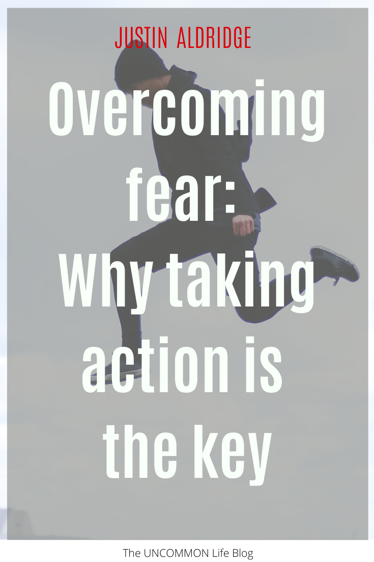 Man jumping through the air in the background behind the text, "Overcoming fear: why taking action is the key" in white font